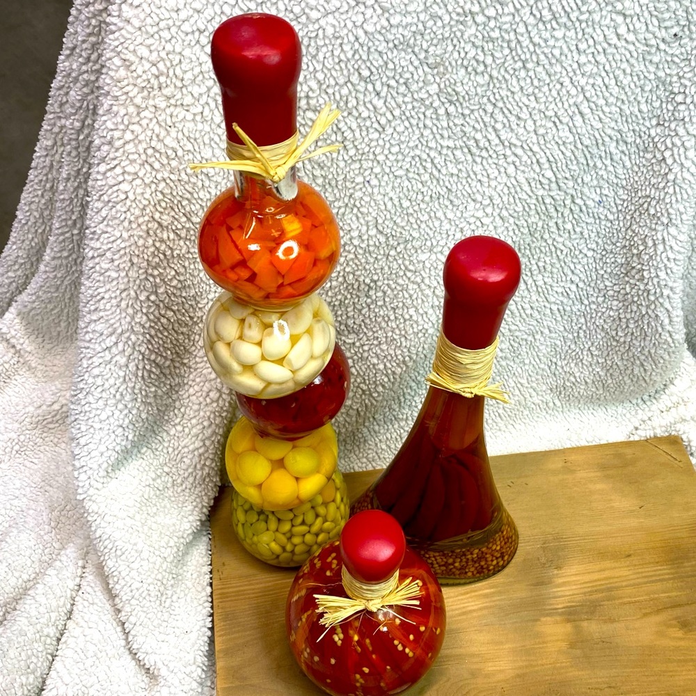Three decorative bottles w/pickled vegetables